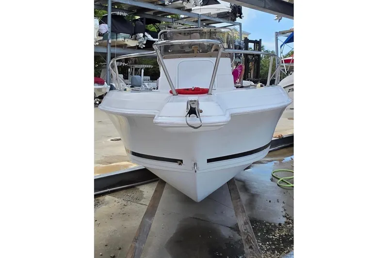 Slide: The Image of 2001 Pro-Line 19 Sport boat on a trailer in a marina setting. - 3