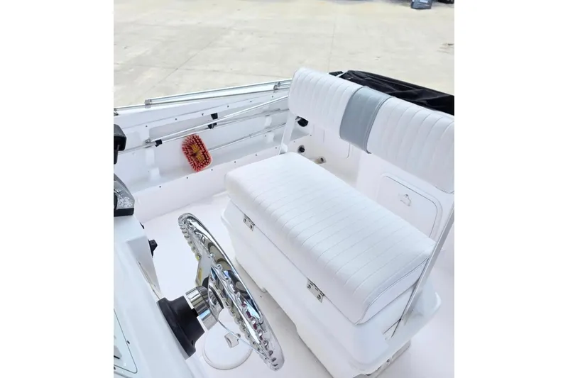 Slide: The Image of 2001 Pro-Line 19 Sport boat interior with white seating and steering wheel. - 4