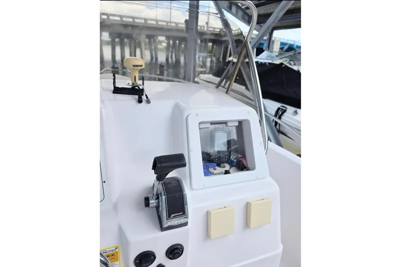 Slide: The Image of 2001 Pro-Line 19 Sport boat dashboard with controls and navigation equipment. - 5