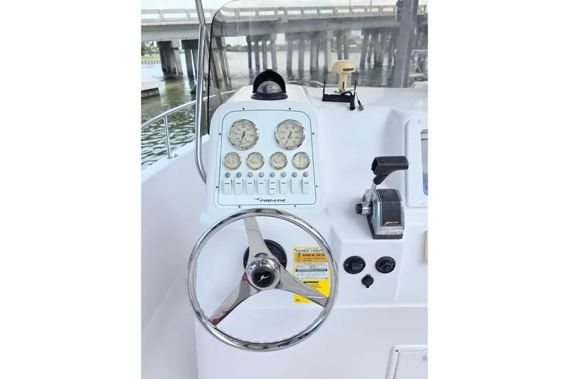 Slide: The Image of Steering console of a 2001 Pro-Line 19 Sport boat with gauges and controls. - 6