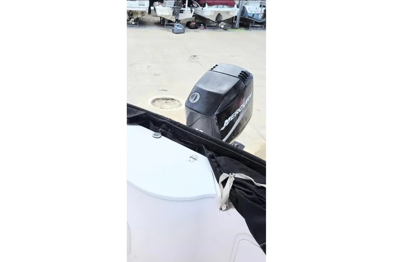 Slide: The Image of 2001 Pro-Line 19 Sport boat with Mercury outboard motor in a storage area. - 8