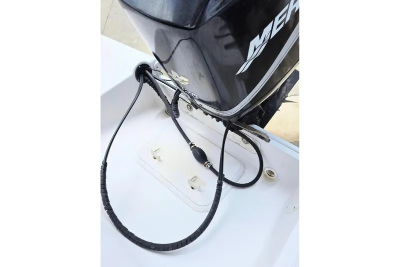 Slide: The Image of Outboard motor on 2001 Pro-Line 19 Sport boat, featuring visible cables and connections. - 9