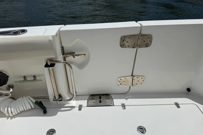 Slide: The Image of 2020 Boston Whaler 330 Outrage boat deck with stainless steel fittings and water hose. - 13
