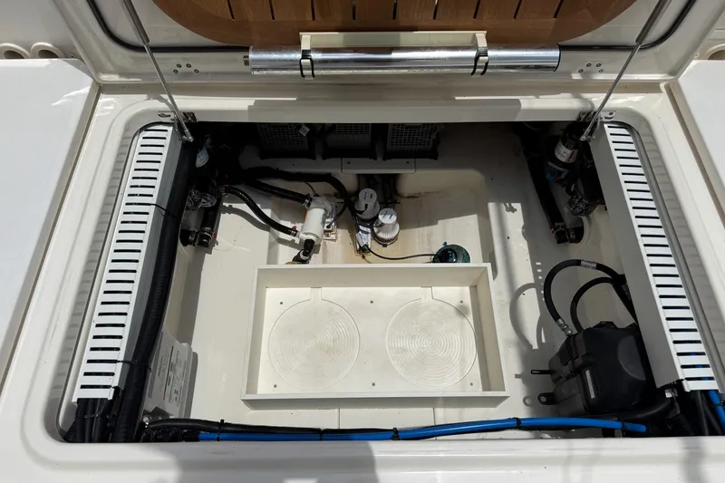 Slide: The Image of Open engine compartment of a 2020 Boston Whaler 330 Outrage boat, showcasing internal components. - 15