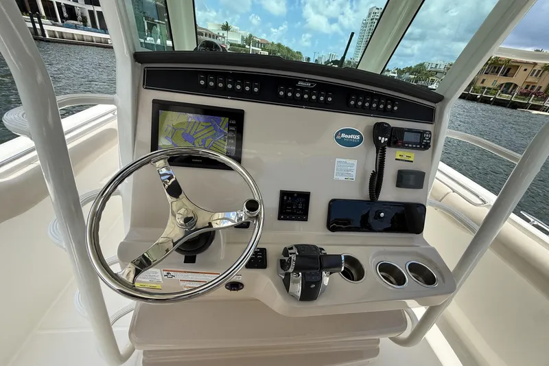 Slide: The Image of Helm of 2020 Boston Whaler 330 Outrage with navigation system and controls. - 4