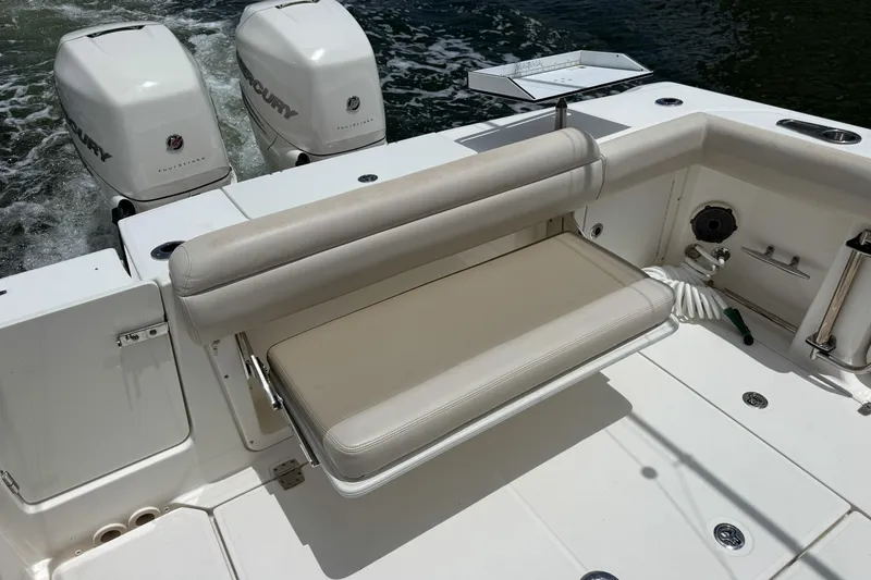 Slide: The Image of 2020 Boston Whaler 330 Outrage boat with dual Mercury engines and foldable seating. - 6