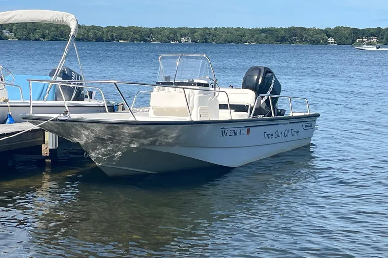 The Image of 2010 Boston Whaler 170 Montauk boat docked on a serene lake. - 0