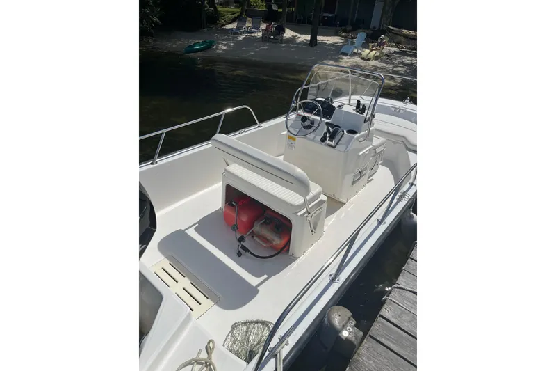 Slide: The Image of 2010 Boston Whaler 170 Montauk boat interior with steering console and seating. - 1