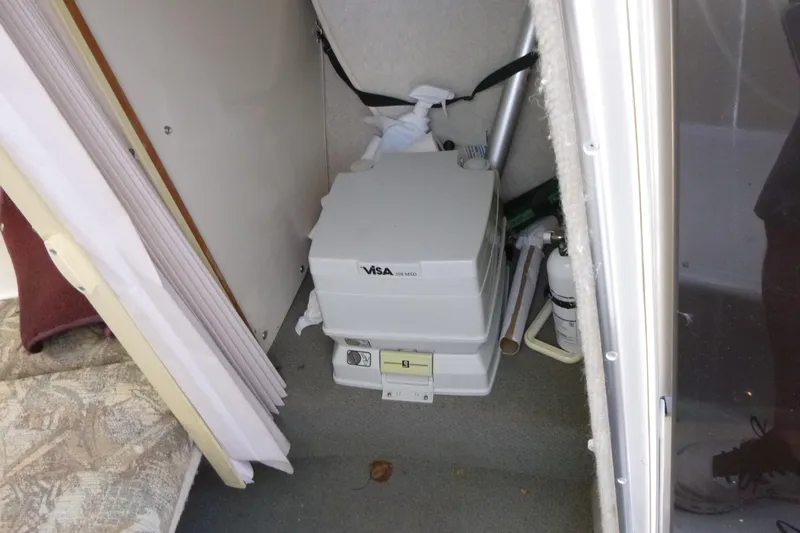 Slide: The Image of Portable toilet inside 1998 Maxum 2300 SC boat cabin. - 13
