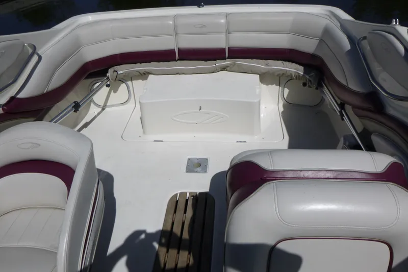Slide: The Image of Interior of a 1998 Maxum 2300 SC boat with white and maroon seating. - 7