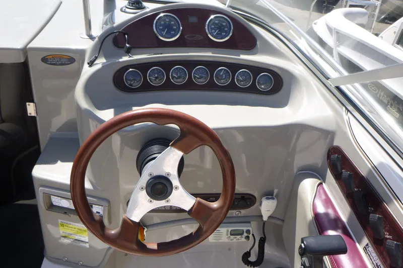 Slide: The Image of 1998 Maxum 2300 SC boat dashboard with gauges and steering wheel. - 9