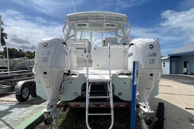 Slide: The Image of 2023 World Cat 325 DC boat with dual Yamaha 300 V6 engines, docked outdoors. - 3