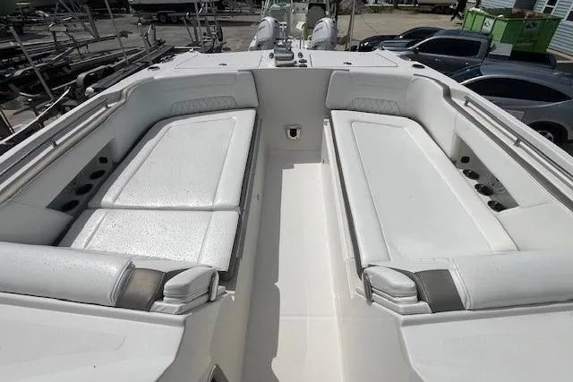 Slide: The Image of 2023 World Cat 325 DC boat interior with white seating and storage compartments. - 4