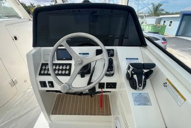 Slide: The Image of Helm of 2023 World Cat 325 DC boat with steering wheel and controls. - 5