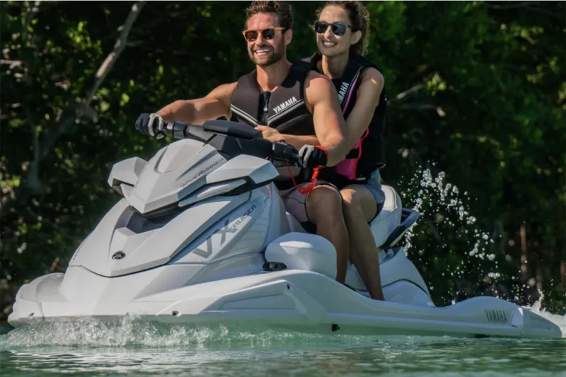 Slide: The Image of Manufacturer Provided Image: Couple enjoying a ride on a 2025 Yamaha WaveRunner VX Cruiser in clear water. - 2