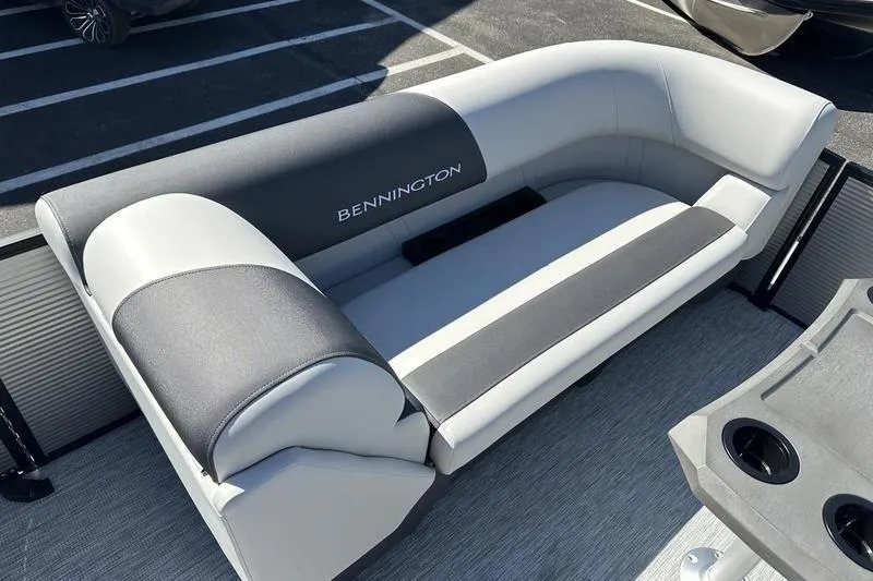 Slide: The Image of 2026 Bennington 22 S Quad Bench boat seating in gray and black upholstery. - 10