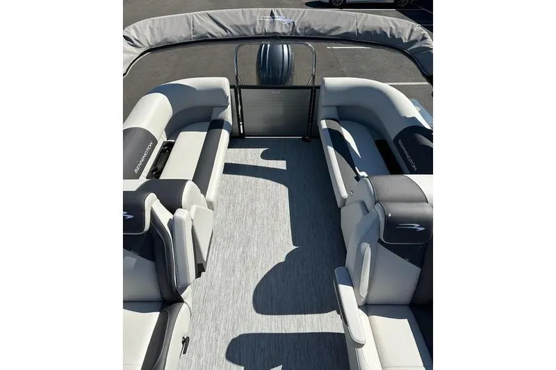 Slide: The Image of 2026 Bennington 22 S Quad Bench pontoon boat interior with spacious seating and modern design. - 14