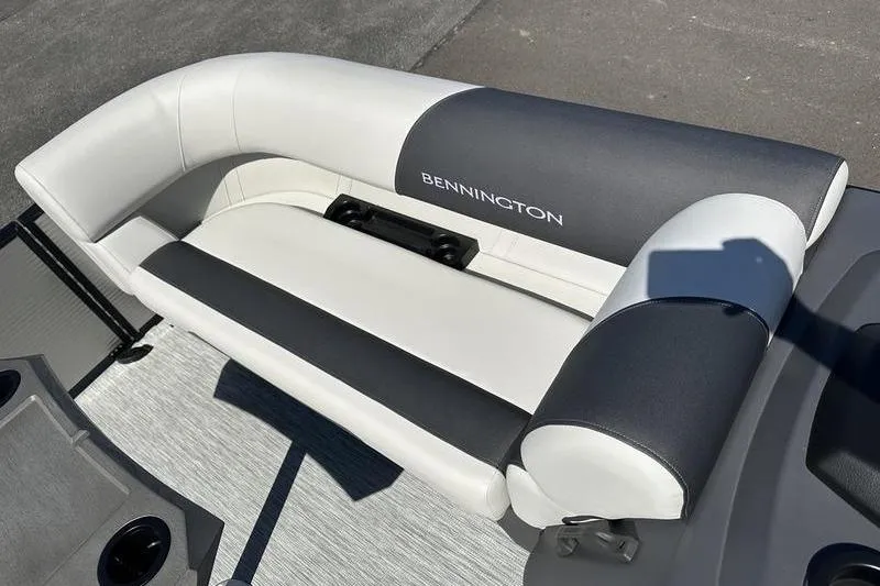 Slide: The Image of 2026 Bennington 22 S Quad Bench boat seat, featuring sleek white and gray upholstery. - 16