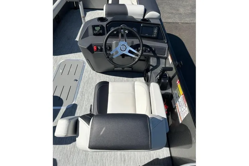 Slide: The Image of 2026 Bennington 22 S Quad Bench boat interior with steering wheel and seating. - 6