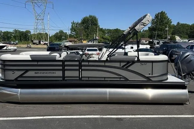 Slide: The Image of 2026 Bennington 22 S Quad Bench pontoon boat in a parking lot. - 8