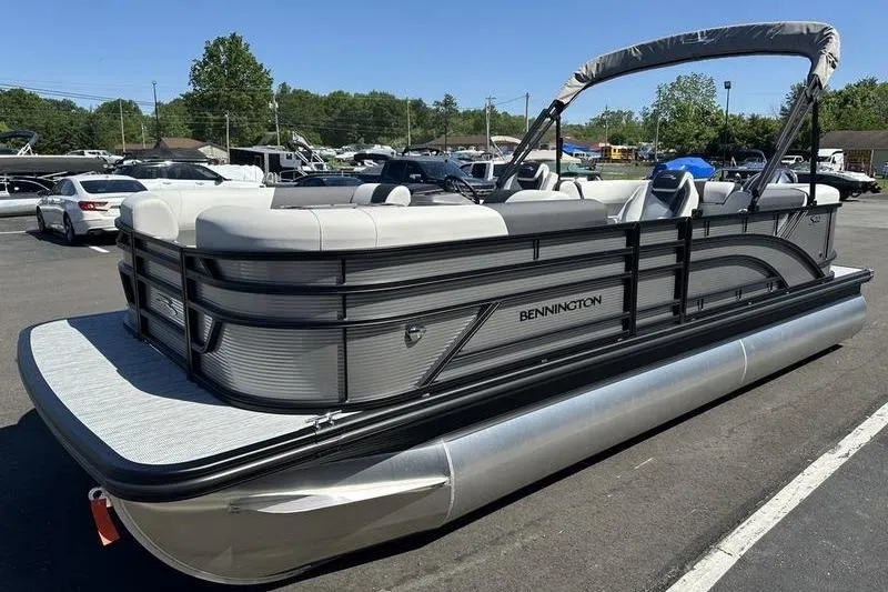 Slide: The Image of 2026 Bennington 22 S Quad Bench pontoon boat in a parking lot. - 9