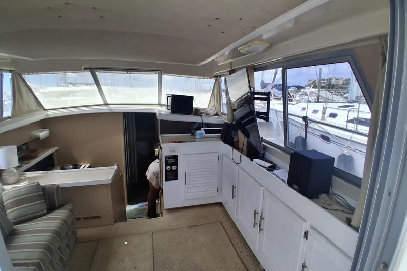 Slide: The Image of Interior of a 1986 Silverton 34 Convertible yacht with seating and windows. - 11