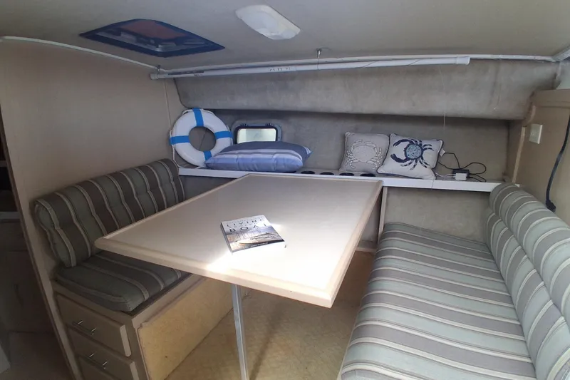 Slide: The Image of Interior of 1986 Silverton 34 Convertible with striped seating and nautical decor. - 14