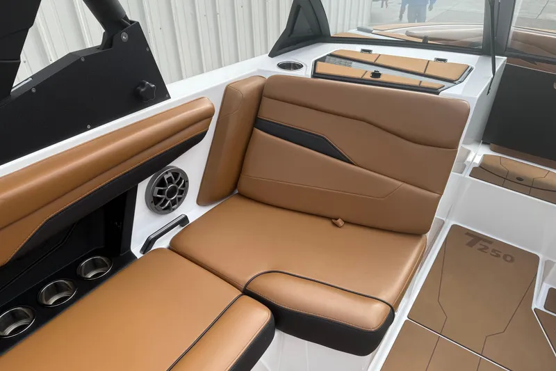 Slide: The Image of 2022 Axis T250 boat interior with tan leather seating and cup holders. - 12