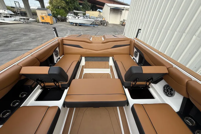 Slide: The Image of 2022 Axis T250 boat interior with brown leather seating and cup holders. - 13