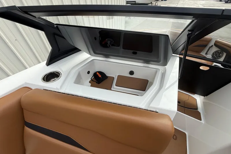 Slide: The Image of 2022 Axis T250 boat interior with tan seating and storage compartment. - 14