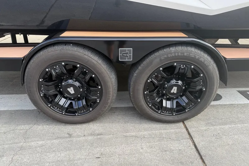 Slide: The Image of Black wheels on a 2022 Axis T250 trailer, featuring Milestar tires. - 17