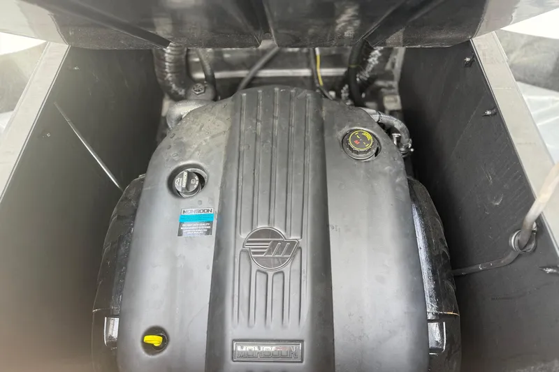 Slide: The Image of Engine compartment of a 2022 Axis T250 boat, featuring a Monsoon engine. - 19
