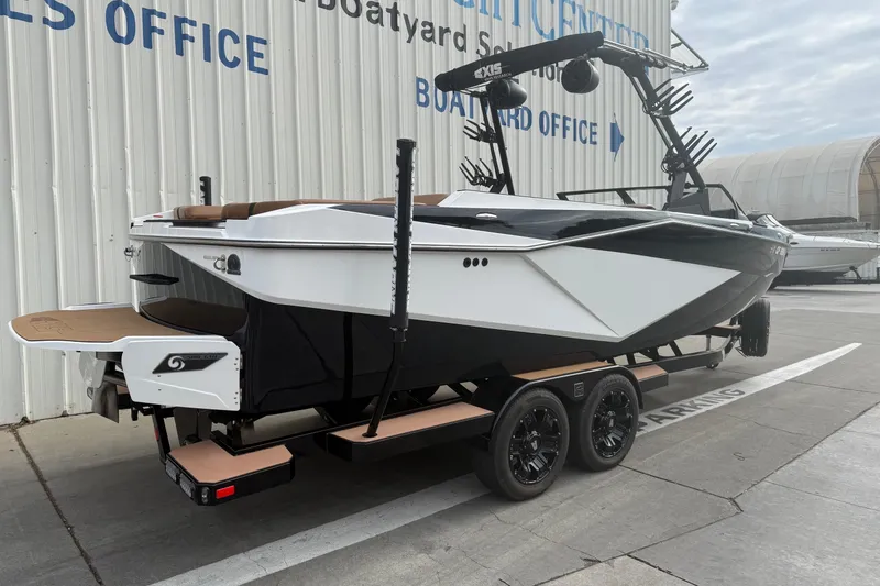 Slide: The Image of 2022 Axis T250 boat on trailer at dealership, showcasing sleek design and modern features. - 6