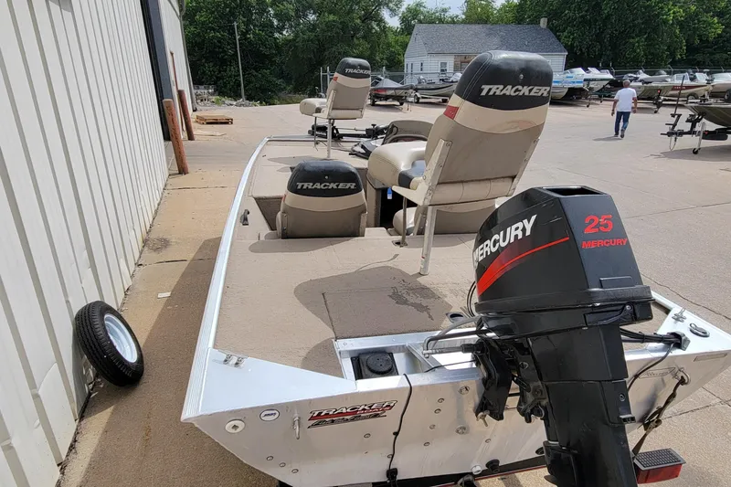 Slide: The Image of 2003 Tracker Pro Team 165 boat with Mercury 25 engine, parked outdoors. - 12