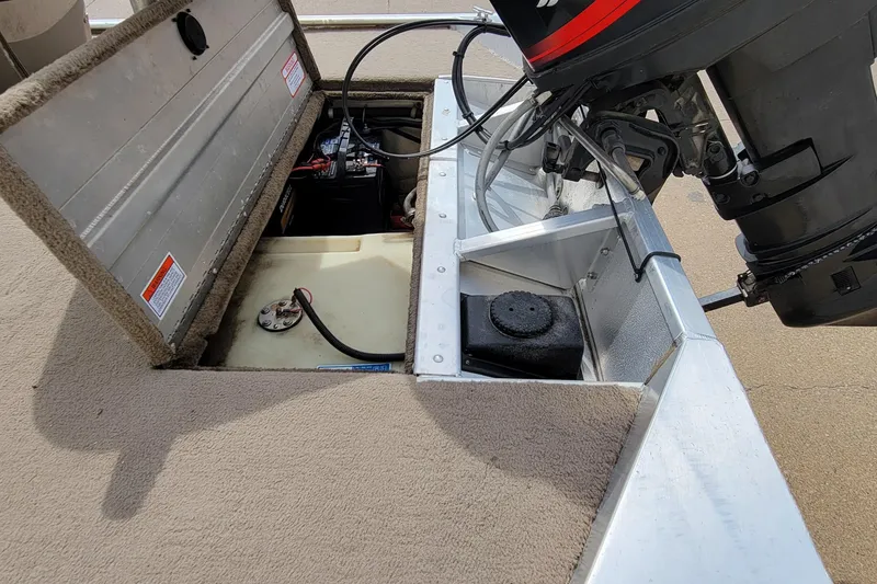 Slide: The Image of Open engine compartment of 2003 Tracker Pro Team 165 boat showing battery and fuel tank. - 13