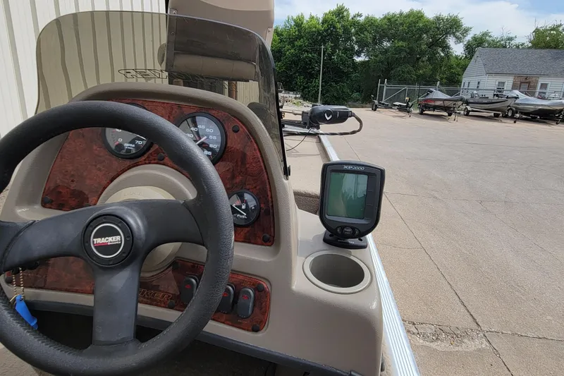 Slide: The Image of 2003 Tracker Pro Team 165 boat dashboard with steering wheel and fish finder. - 20