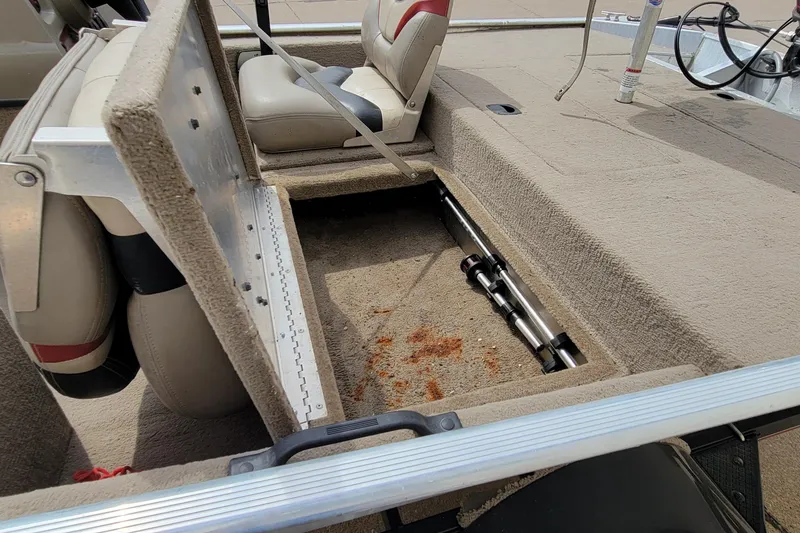 Slide: The Image of 2003 Tracker Pro Team 165 boat interior with open storage compartment and seating. - 21