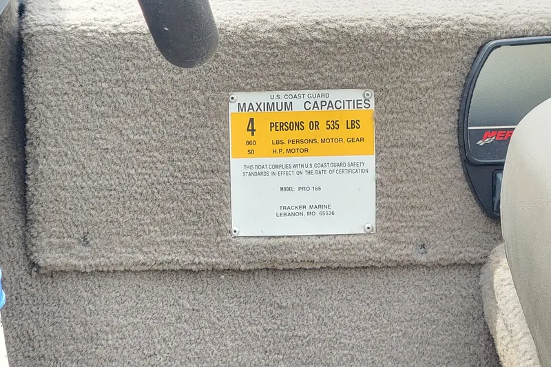 Slide: The Image of 2003 Tracker Pro Team 165 capacity plate, showing limits for persons and weight. - 22