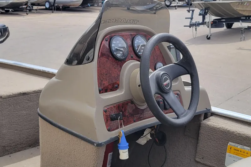 Slide: The Image of 2003 Tracker Pro Team 165 boat dashboard with steering wheel and gauges. - 23