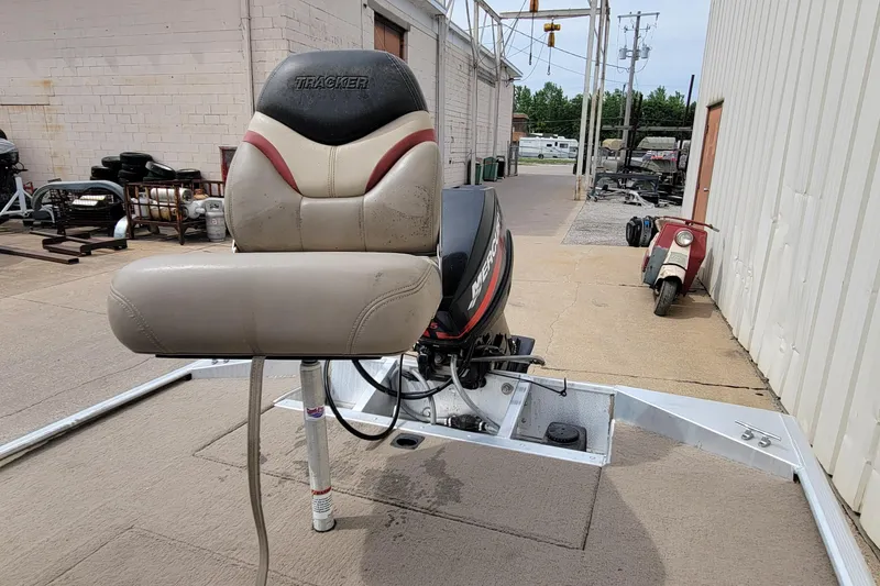 Slide: The Image of 2003 Tracker Pro Team 165 boat seat and motor in an outdoor setting. - 27