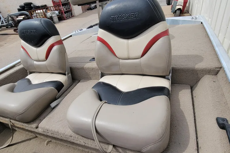 Slide: The Image of 2003 Tracker Pro Team 165 boat seats with beige, black, and red upholstery. - 28