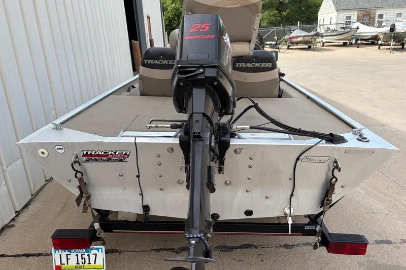 Slide: The Image of 2003 Tracker Pro Team 165 boat with Mercury 25 engine, parked on a trailer. - 3