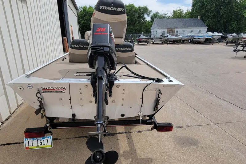 Slide: The Image of 2003 Tracker Pro Team 165 boat with Mercury 25 engine, parked outdoors. - 30