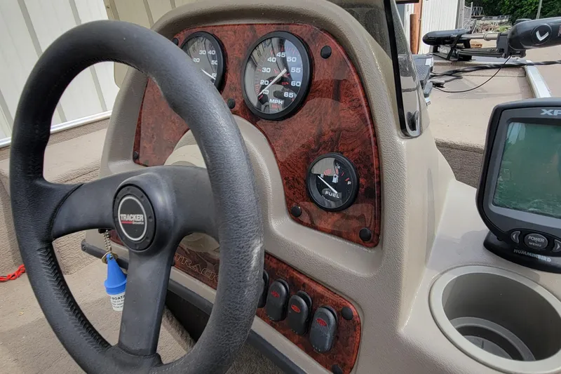 Slide: The Image of 2003 Tracker Pro Team 165 boat dashboard with steering wheel and gauges. - 32