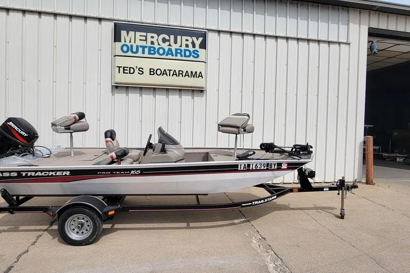 Slide: The Image of 2003 Tracker Pro Team 165 boat on trailer at Ted's Boatarama, Mercury Outboards sign visible. - 4
