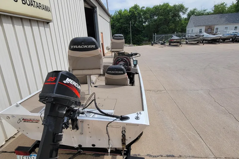 Slide: The Image of 2003 Tracker Pro Team 165 boat with Mercury 25 outboard motor at a dealership. - 6