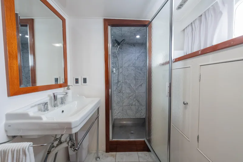 Slide: The Image of Elegant 1939 Mathis Trumpy Fantail Houseboat bathroom with modern sink and shower. - 12
