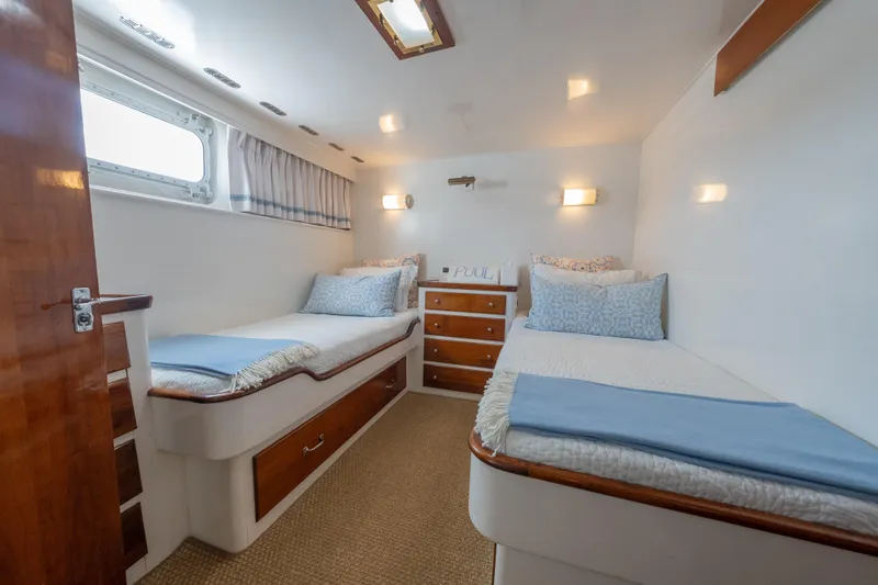 Slide: The Image of Interior of 1939 Mathis Trumpy Fantail Houseboat with twin beds and wooden accents. - 13