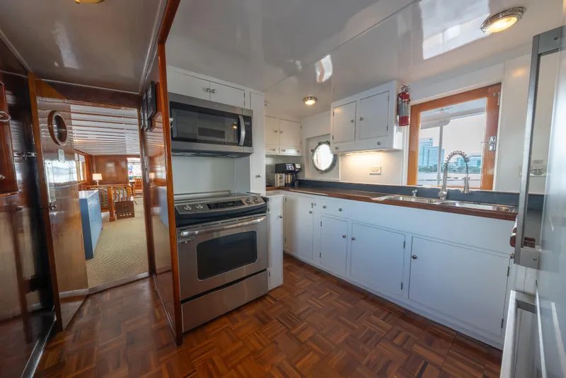 Slide: The Image of Interior of a 1939 Mathis Trumpy Fantail Houseboat kitchen with modern appliances. - 16