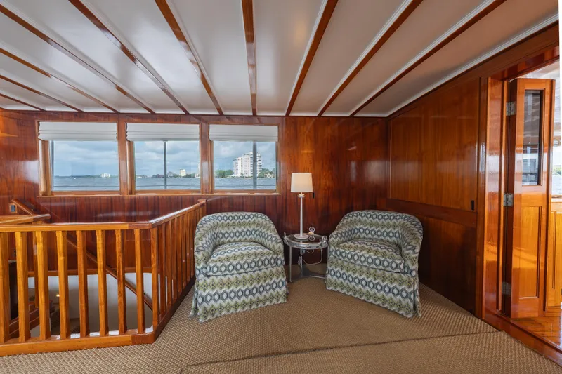 Slide: The Image of Interior of 1939 Mathis Trumpy Fantail Houseboat with wood paneling and patterned chairs. - 2